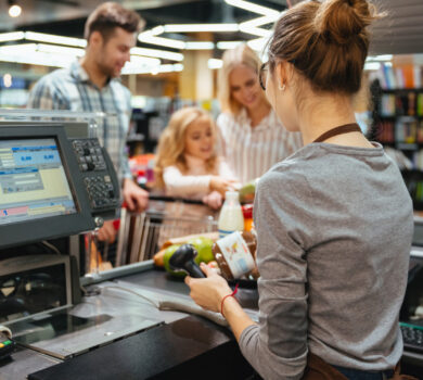 Família parada no balcão enquanto vendedora os atende